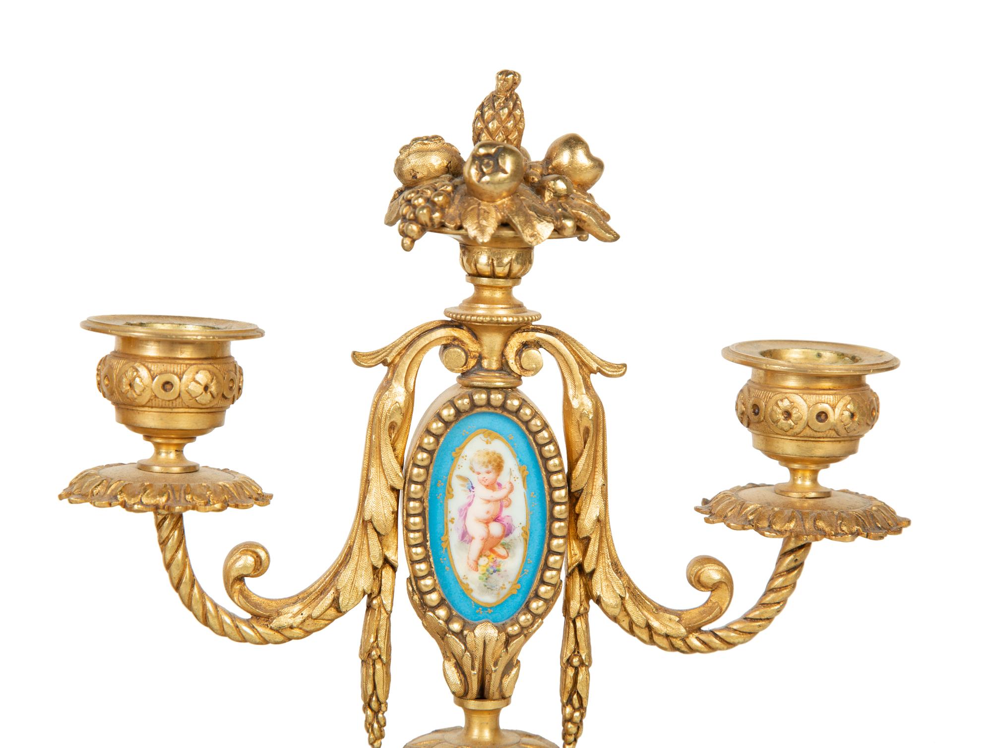 A French Gilt Bronze and Sèvres Porcelain Clock Garniture