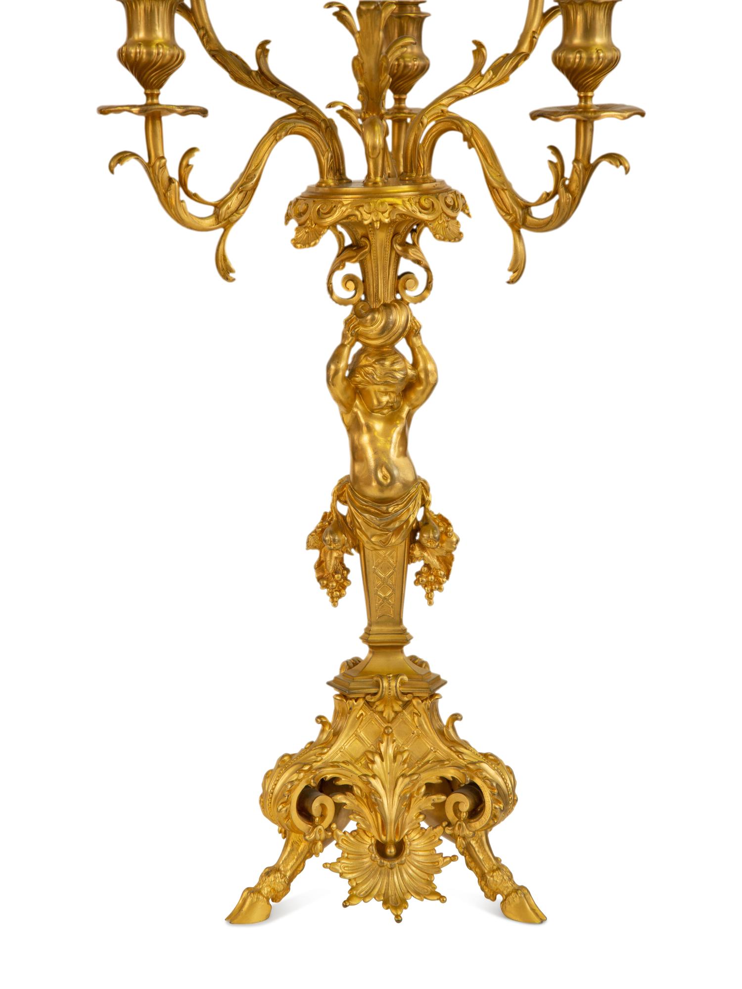 A Pair of Gilt Bronze Figural Seven-Light Candelabra