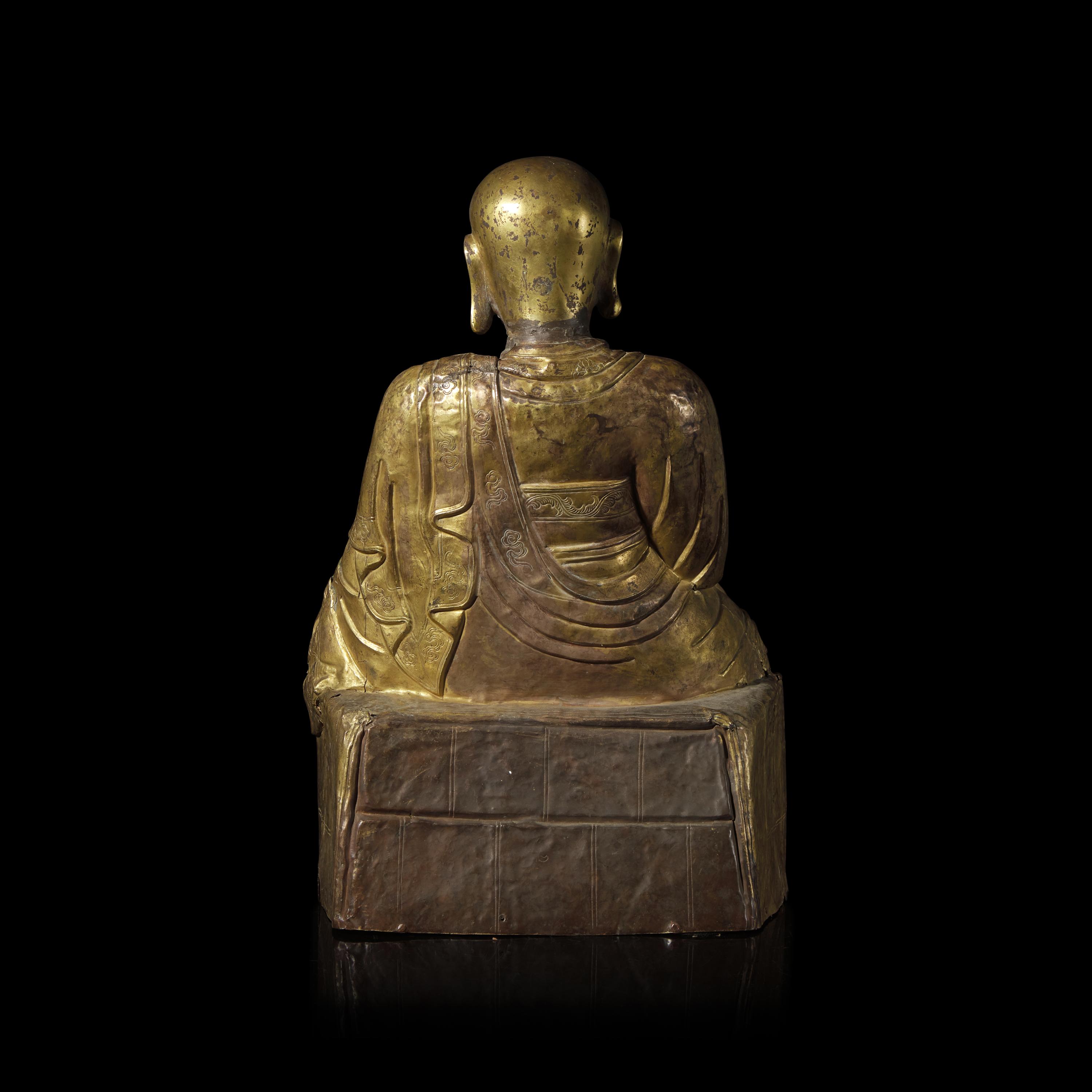 A Mongolian Gilt Copper Repoussé Figure of a Seated Luohan or Monk, 19th Century 清晚期 蒙古銅錘揲羅漢像