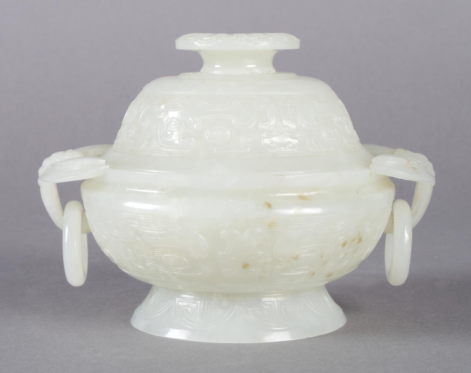 A Near White Jade Lidded Koro, Height 3 1/2 x width (over handles) 4 3/4 x depth 3 7/8 inches.