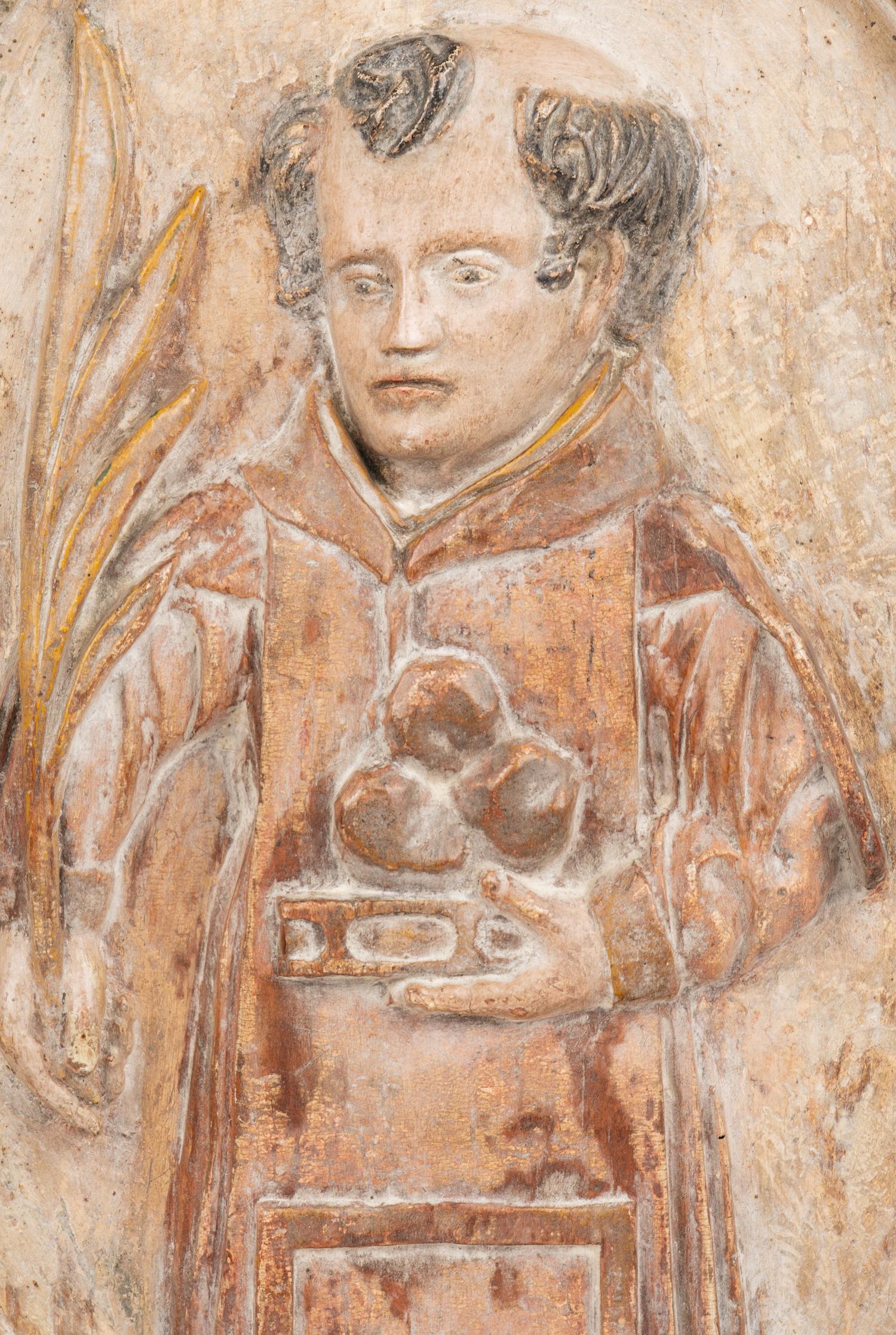 A Continental Carved Wood Plaque Depicting Saint Anthony of Padua