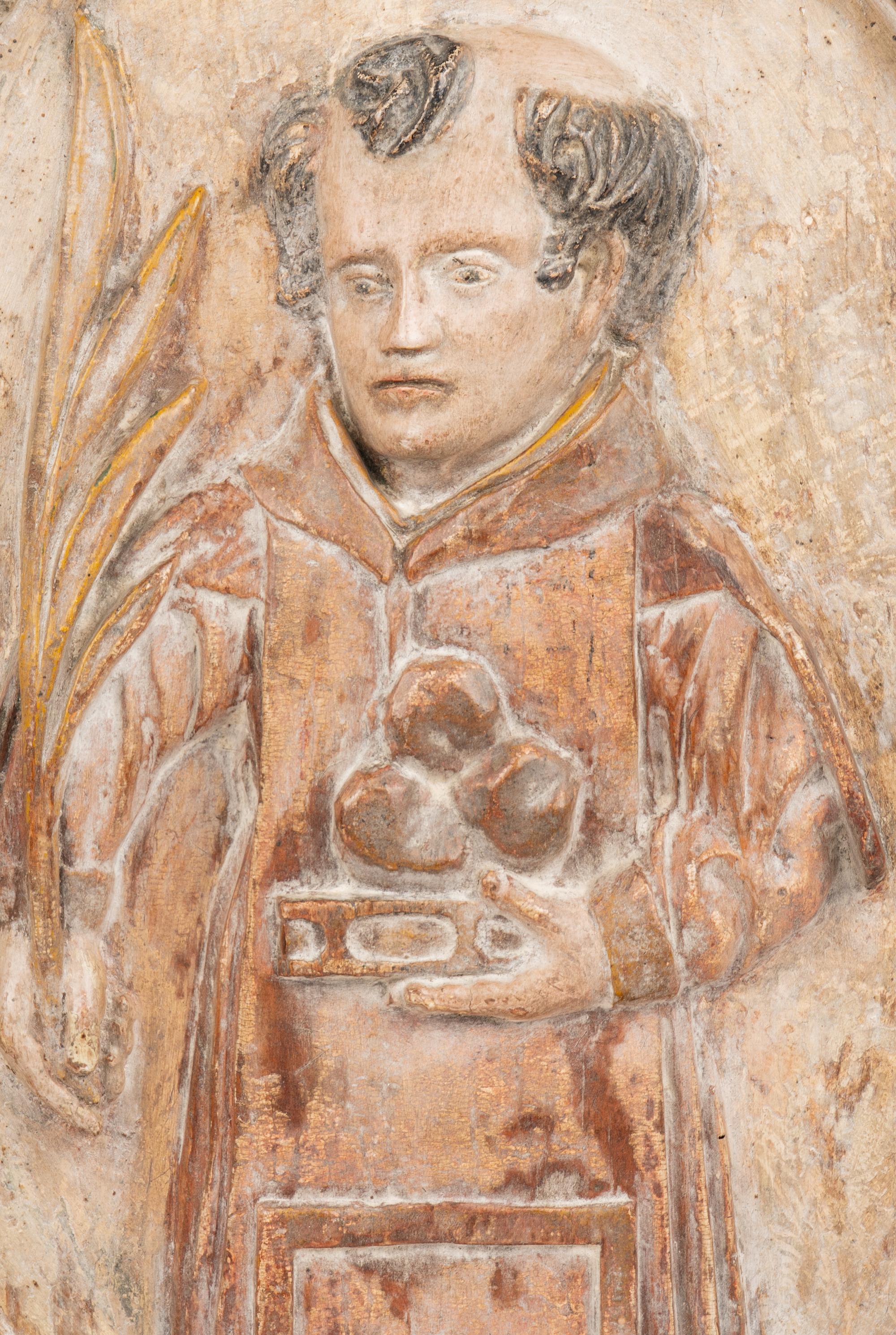 A Continental Carved Wood Plaque Depicting Saint Anthony of Padua