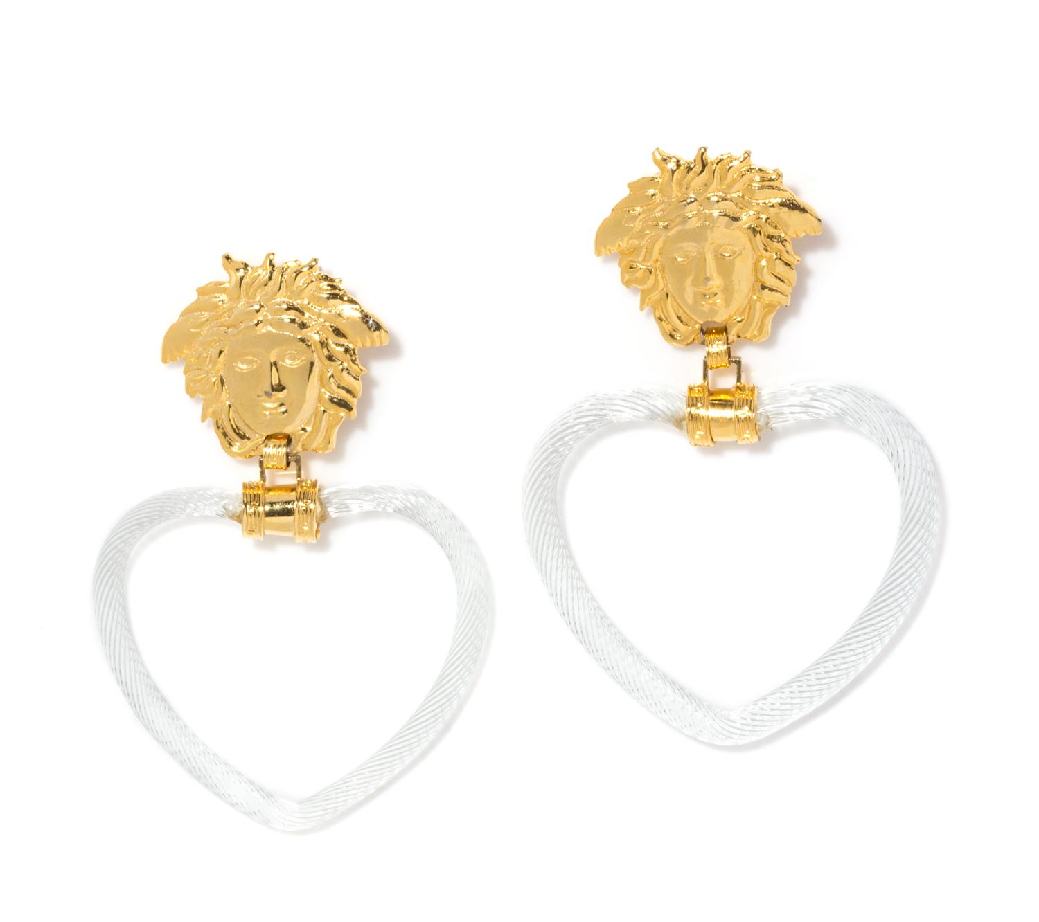 A Pair of Gianni Versace Medusa and Glass Heart Drop Earclips, Medusa: 2" x 1.75"; Drop: 4.5".