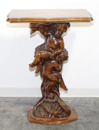 A Carved Walnut Figural Pedestal. Height 39 inches.