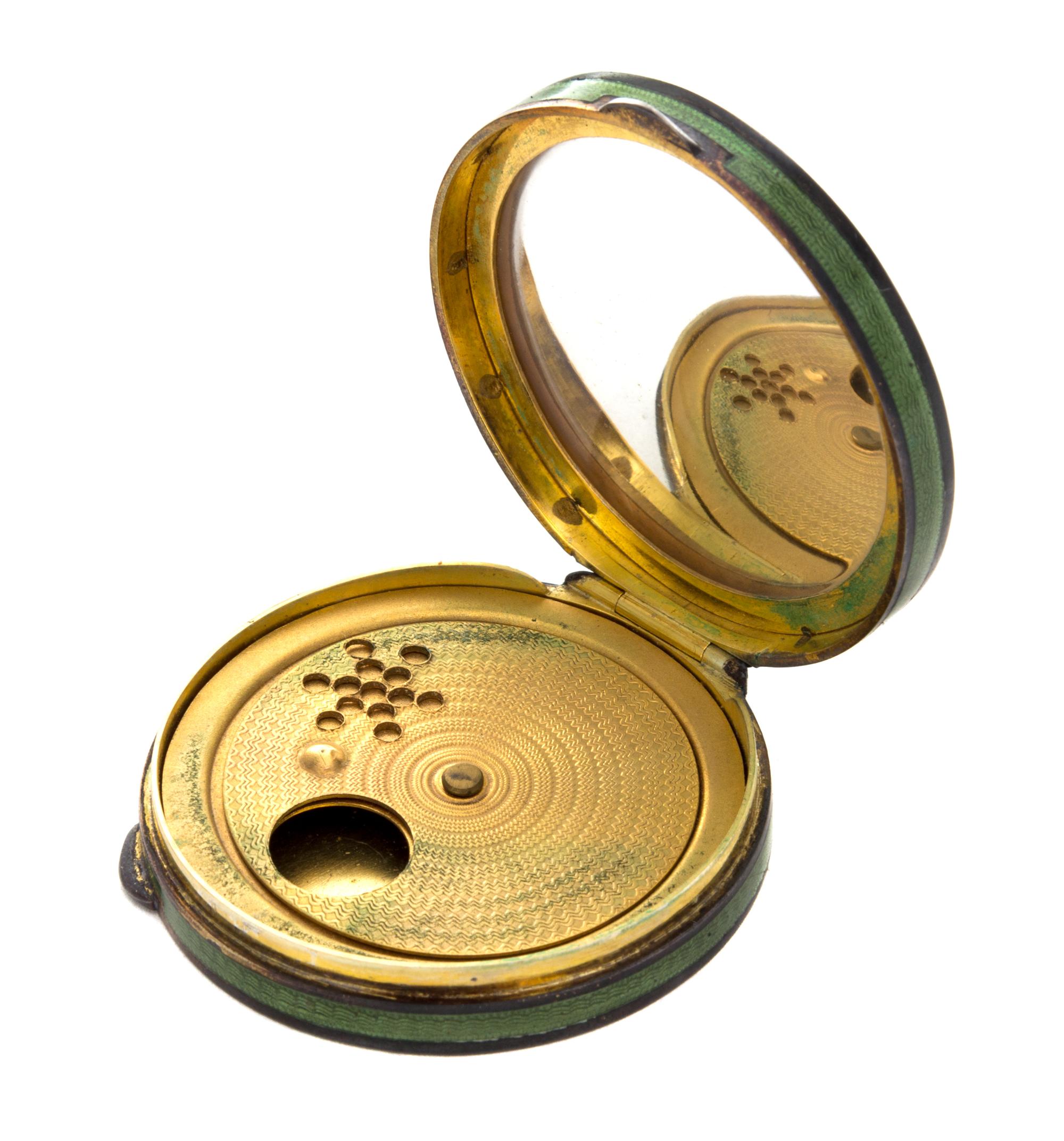 An Austrian Enameled Silver Compact, , of circular form, the lid decorated with a carriage scene, opening to a fitted and mirror inset