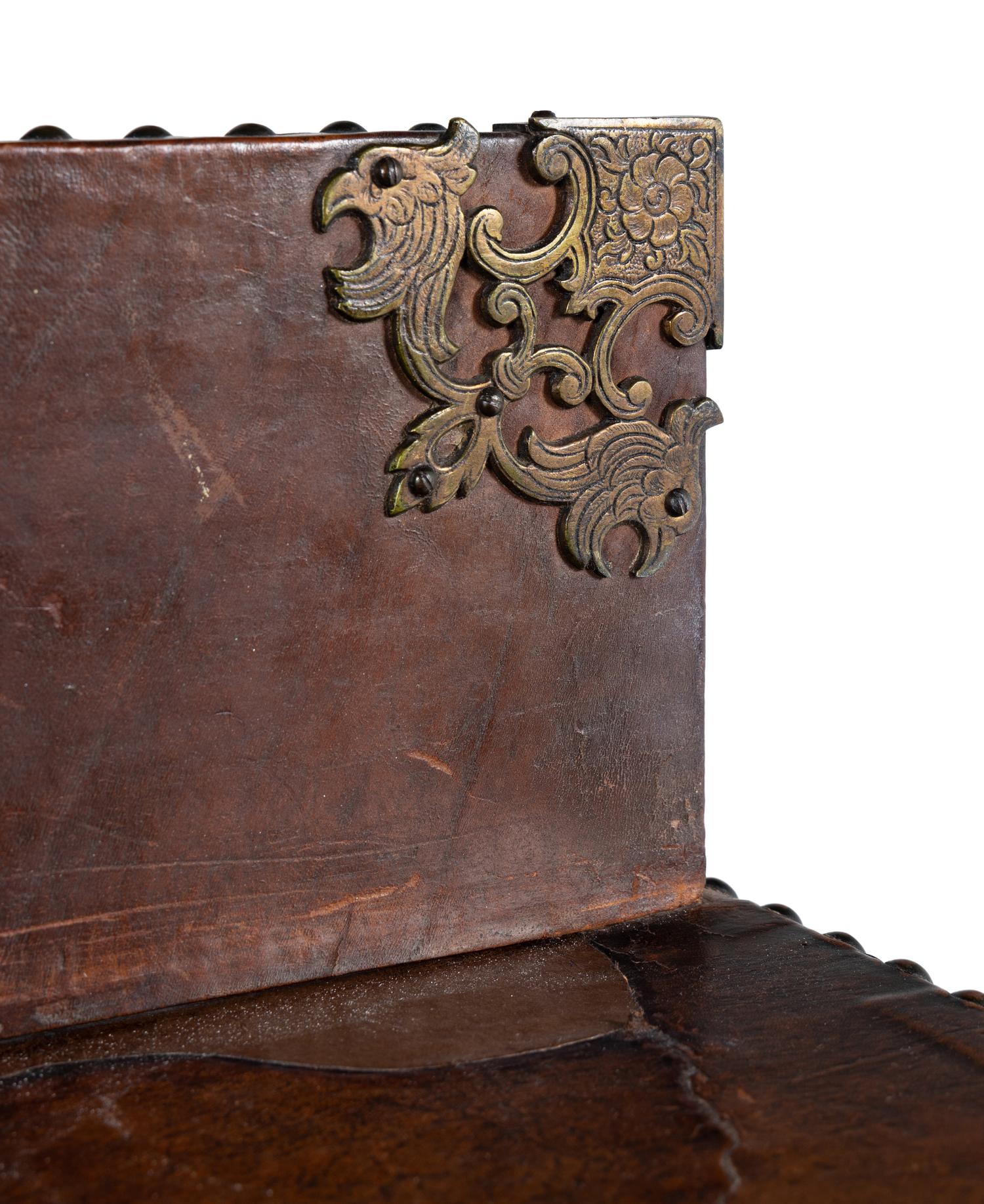 A Spanish Baroque Style Leather-Veneered Side Cabinet