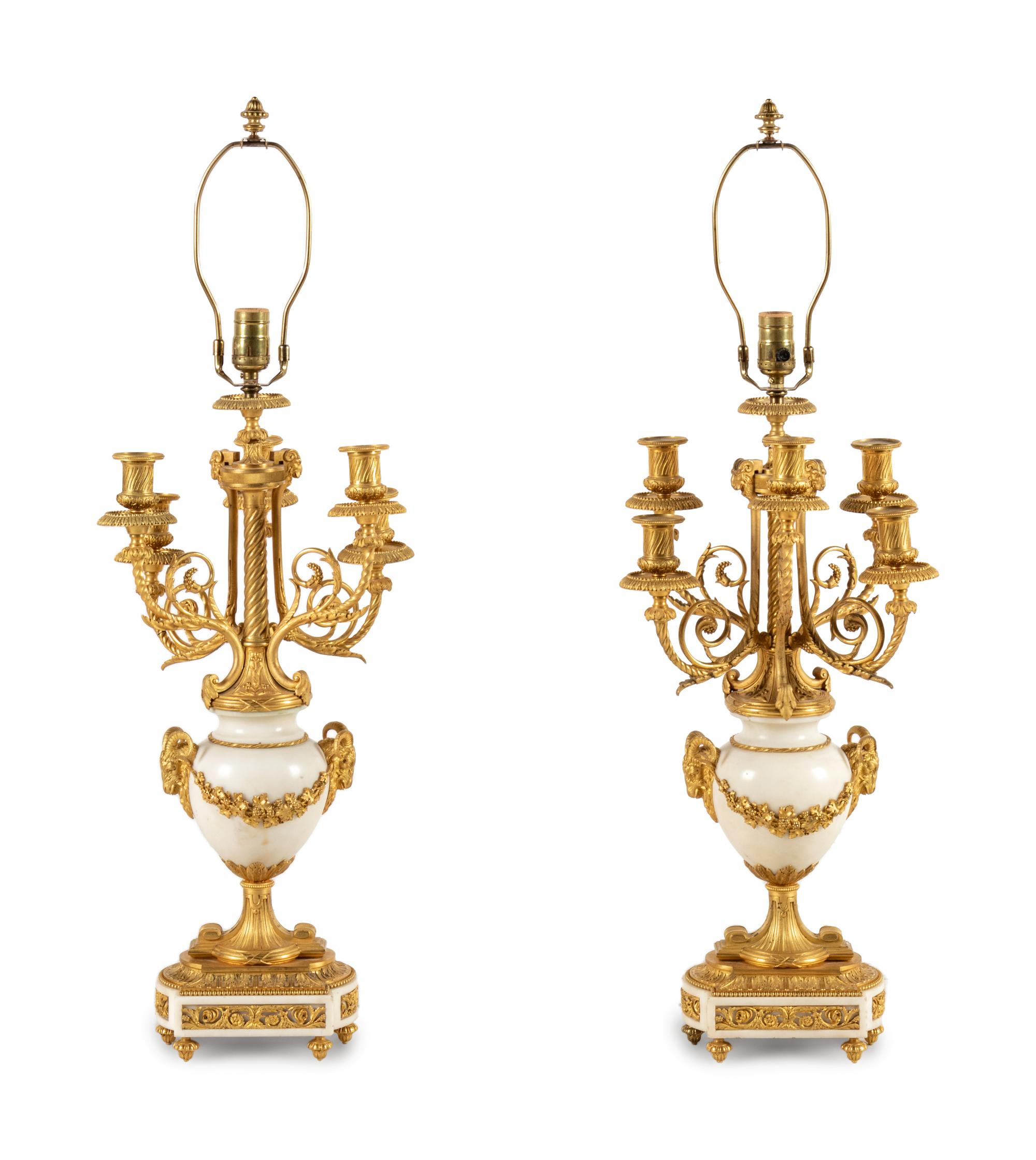 A Pair of Louis XVI Style Gilt Bronze and White Marble Six-Light Candelabra