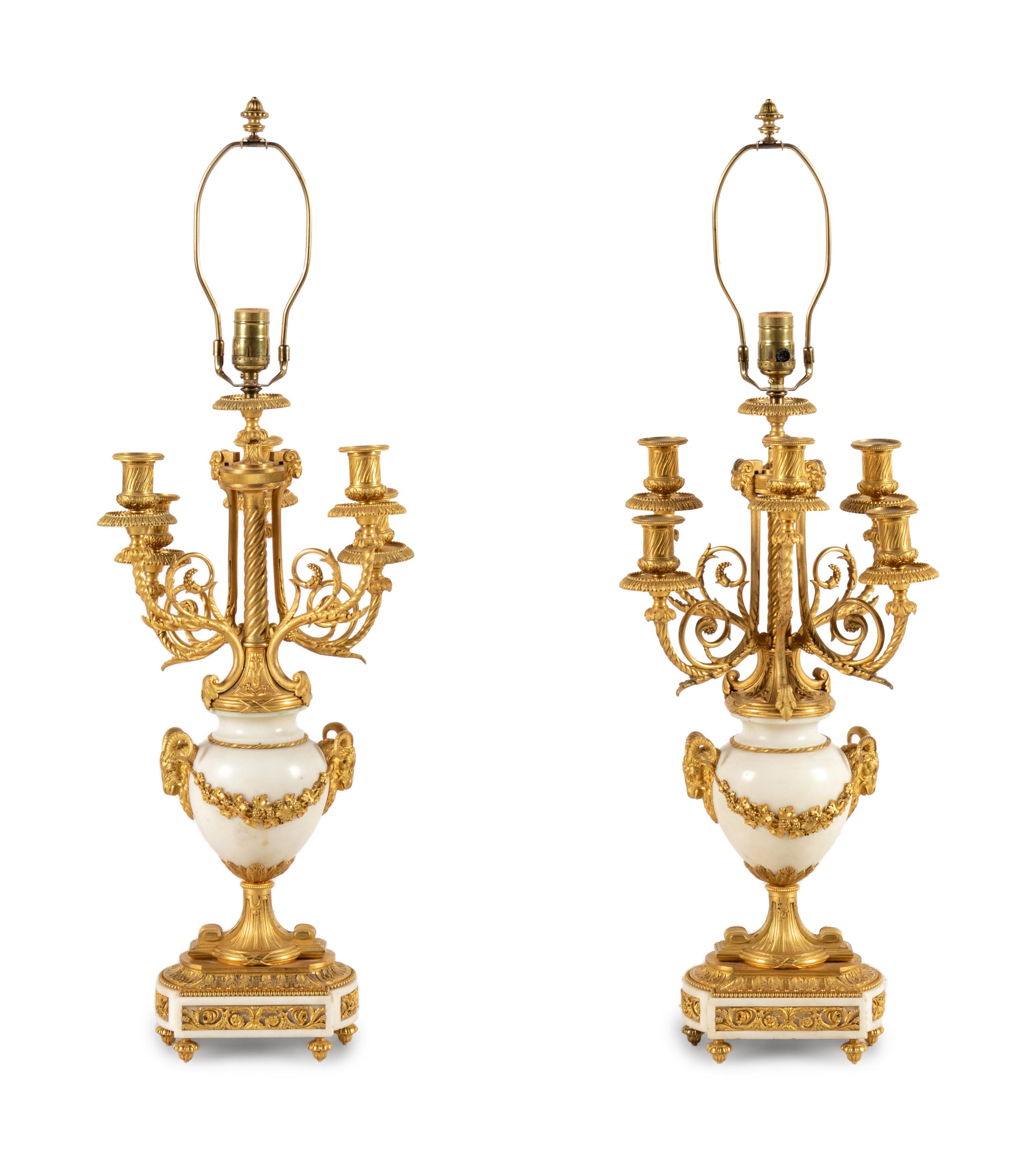 A Pair of Louis XVI Style Gilt Bronze and White Marble Six-Light Candelabra