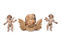 A Continental Carved Cherub Mask with Two Painted Putti