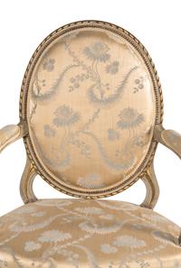 A Pair of Louis XVI Painted and Parcel Gilt Fauteuils