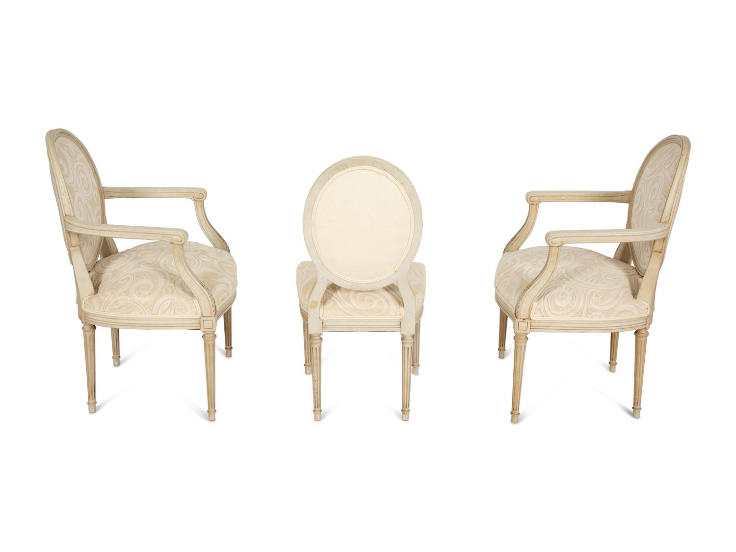 A Pair of Louis XVI Style Oval Back Painted Fauteuils and Matching Side Chair
