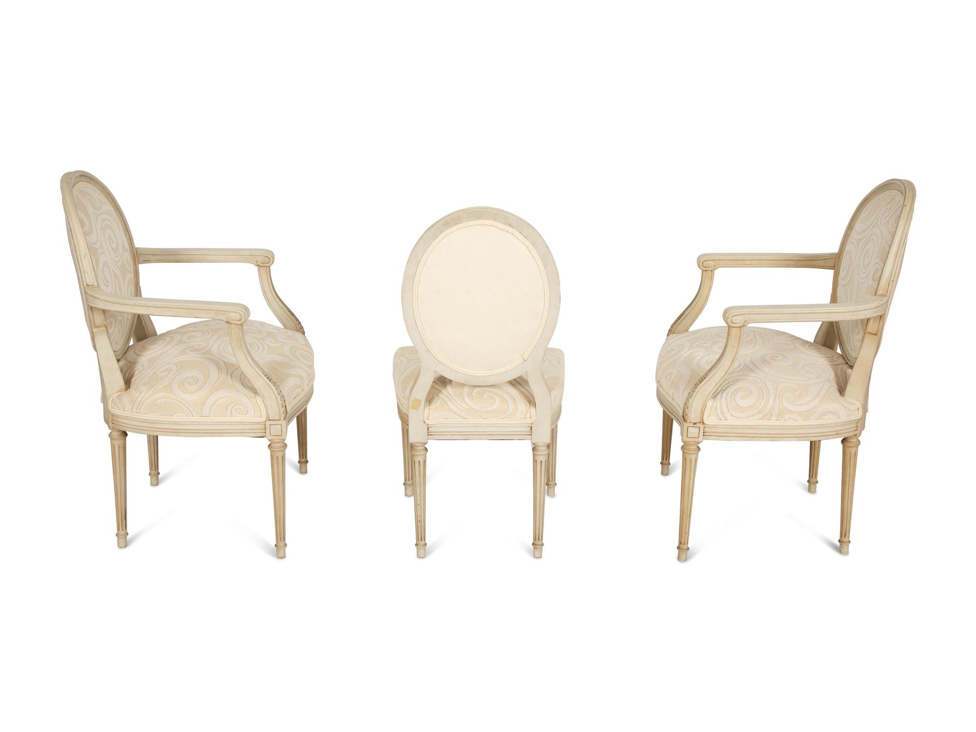 A Pair of Louis XVI Style Oval Back Painted Fauteuils and Matching Side Chair