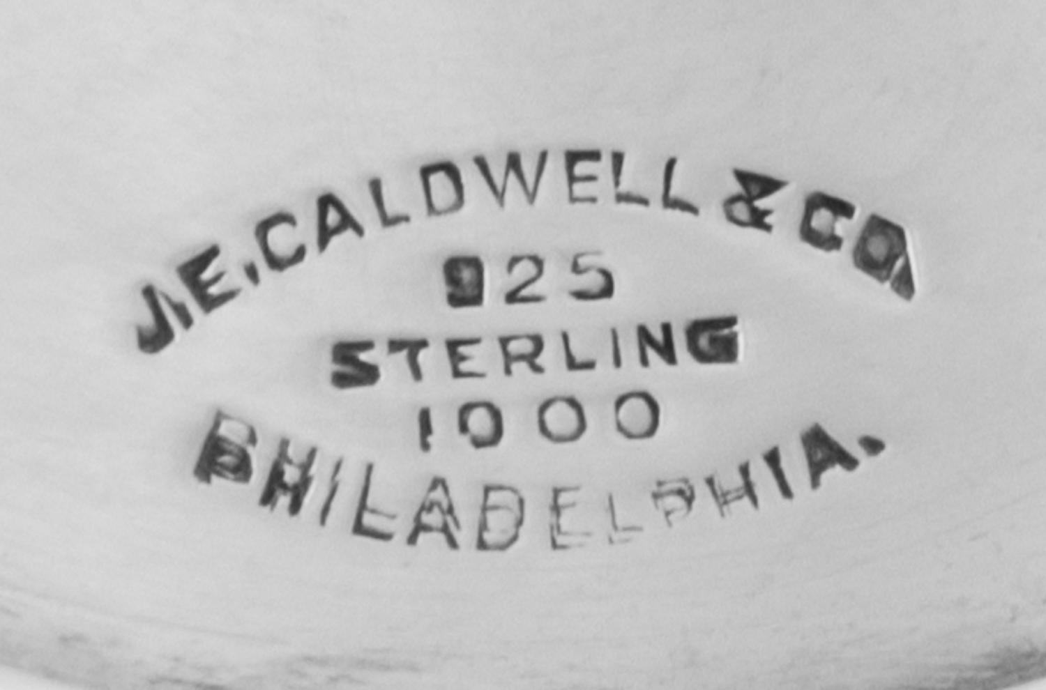 An American Silver Water Pitcher, J.E. Caldwell, Philadelphia, PA, the baluster form body having repousse floral and foliate decoration