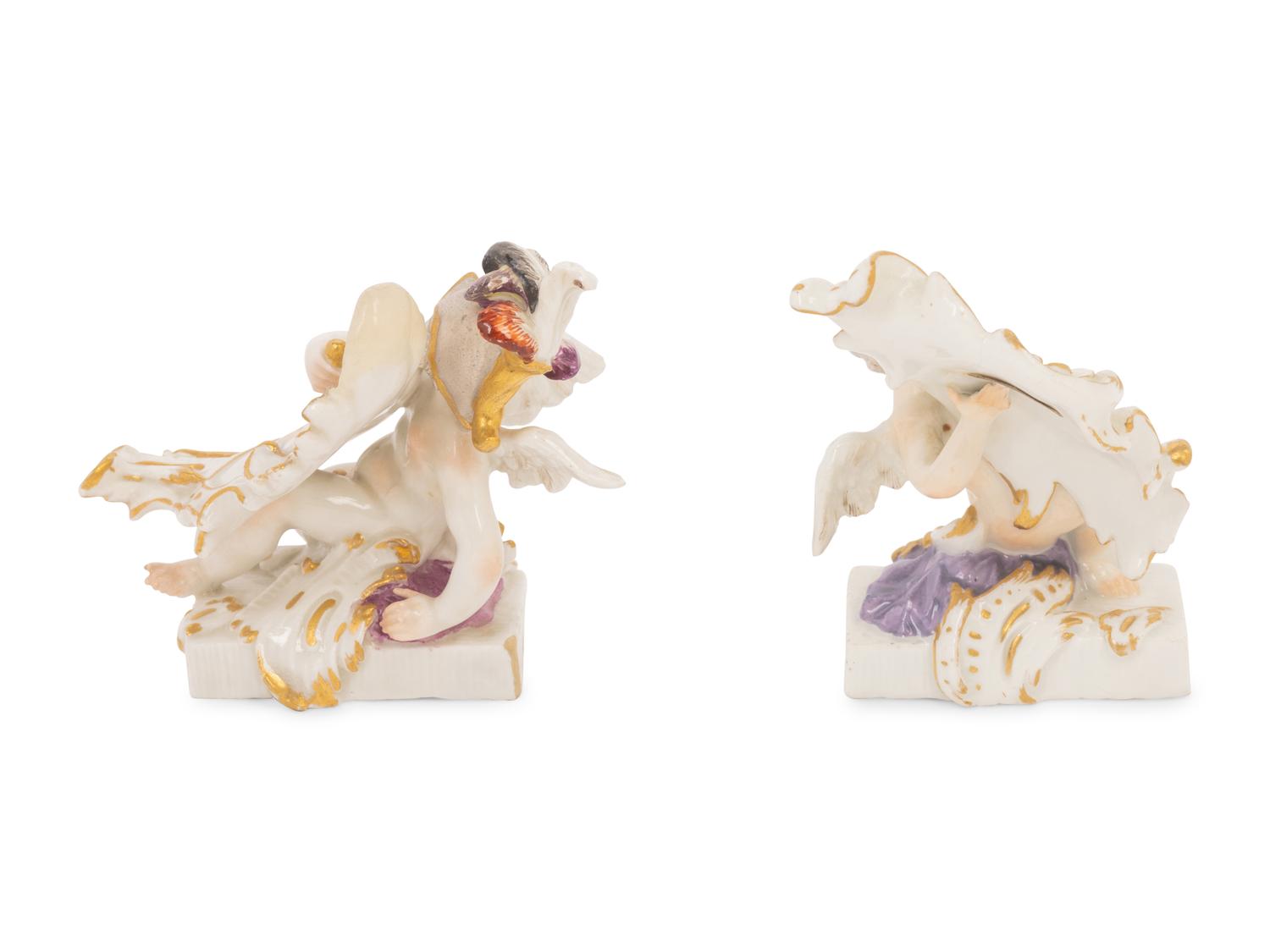 A Pair of Meissen Porcelain Figures of Putti with Cartouches