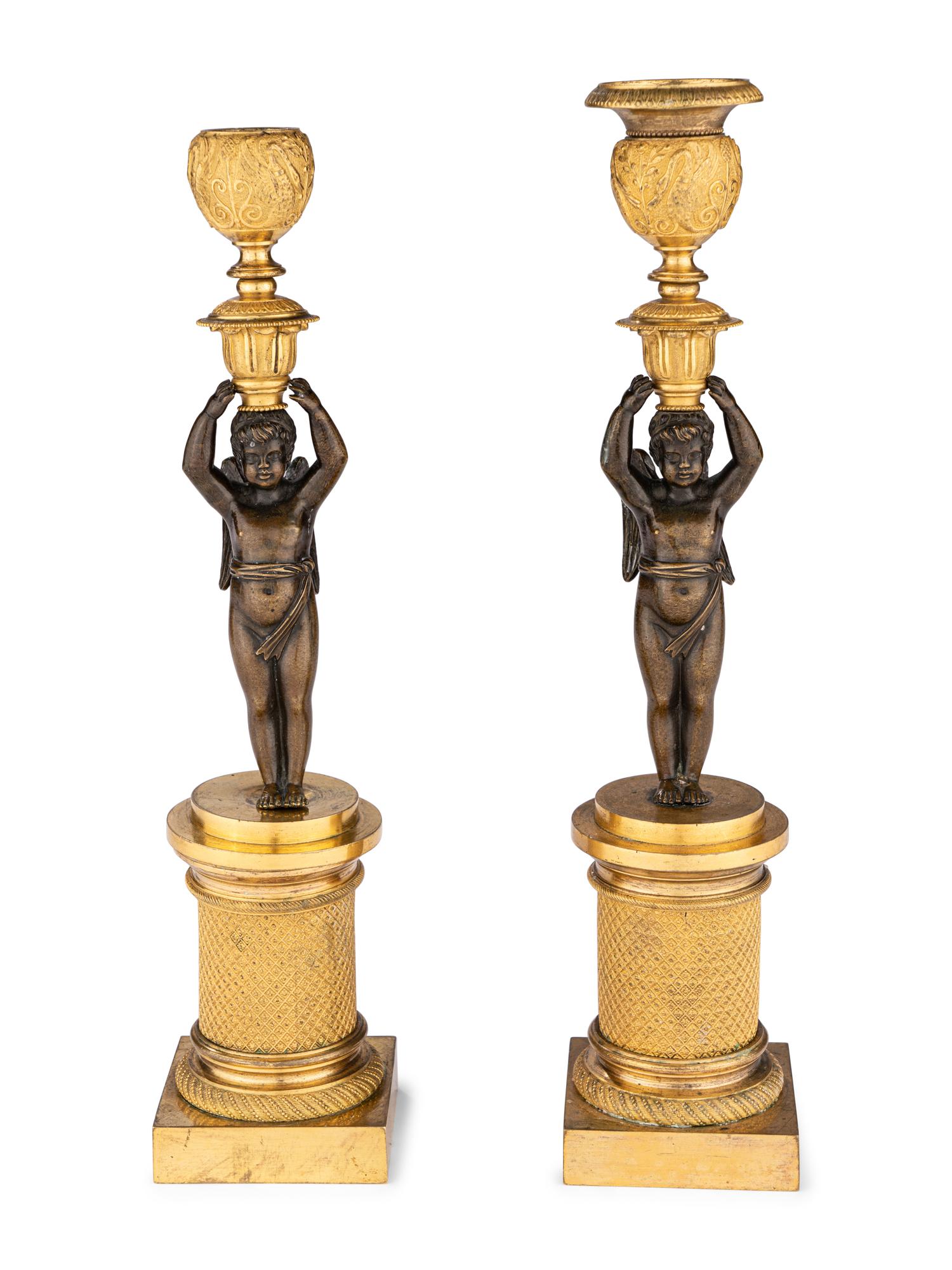 A Pair of Restauration Ormolu and Patinated Bronze Figural Candlesticks