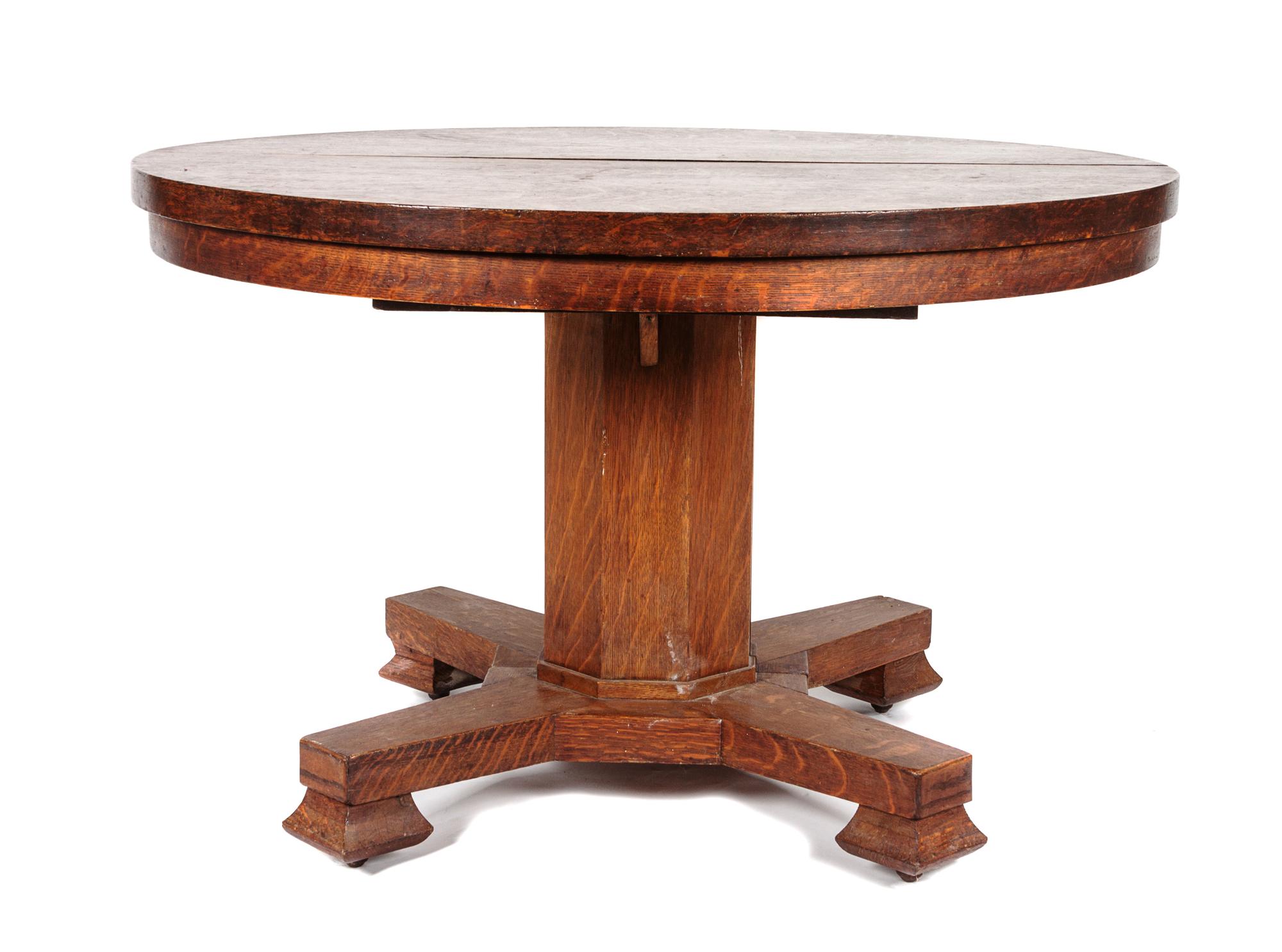 An Arts & Crafts Oak Round Extension Table Height 30 1/2 x diameter 48 inches.