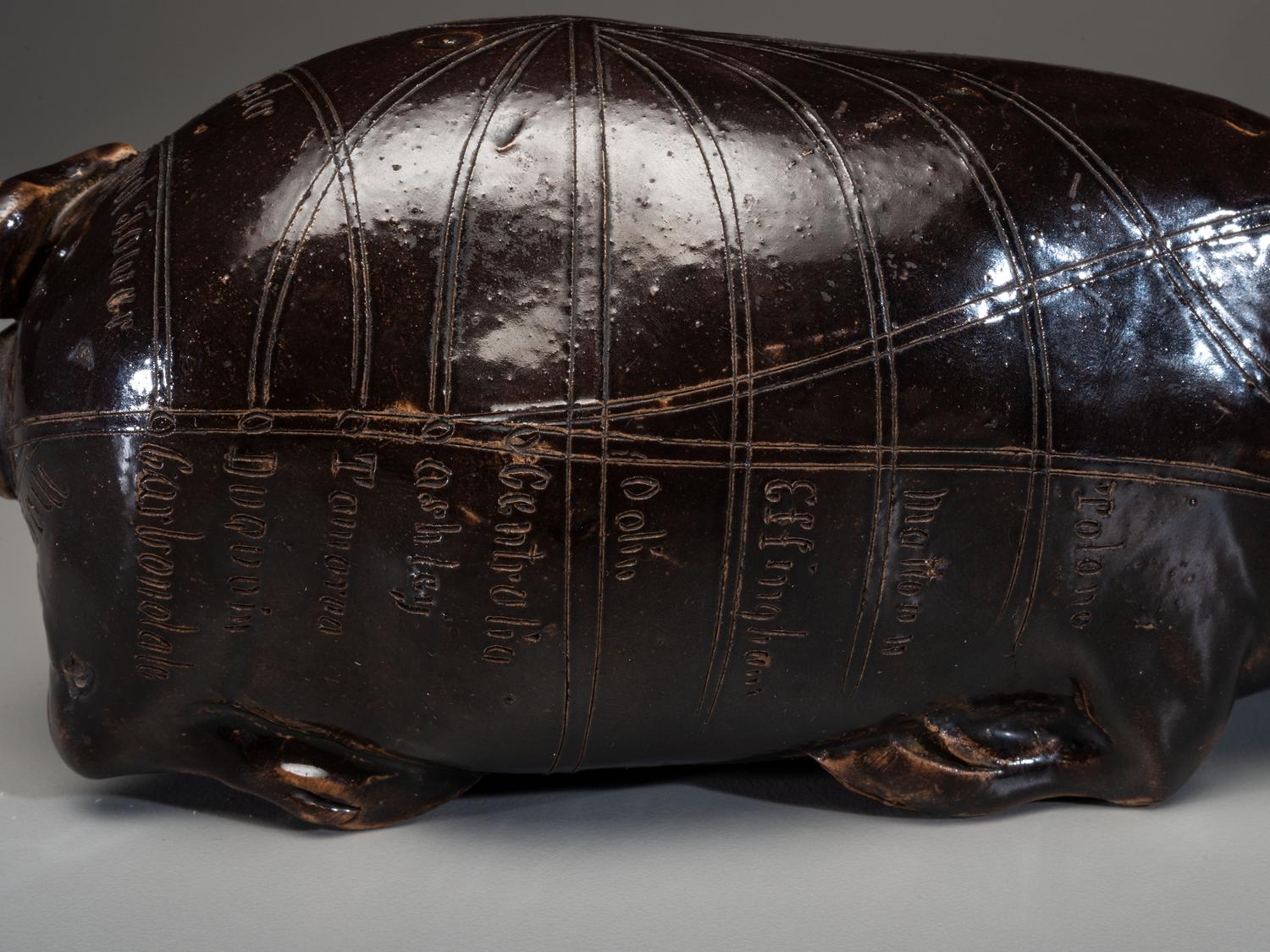 An Anna Pottery Incised and Brown Glazed Pig Flask