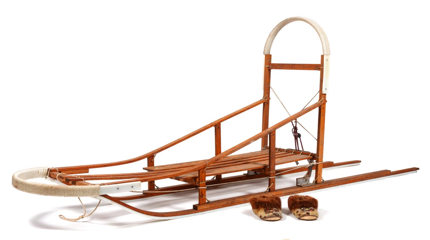 A Dog Sled and a Pair of Eskimo Shoes Length of sled 106 inches.