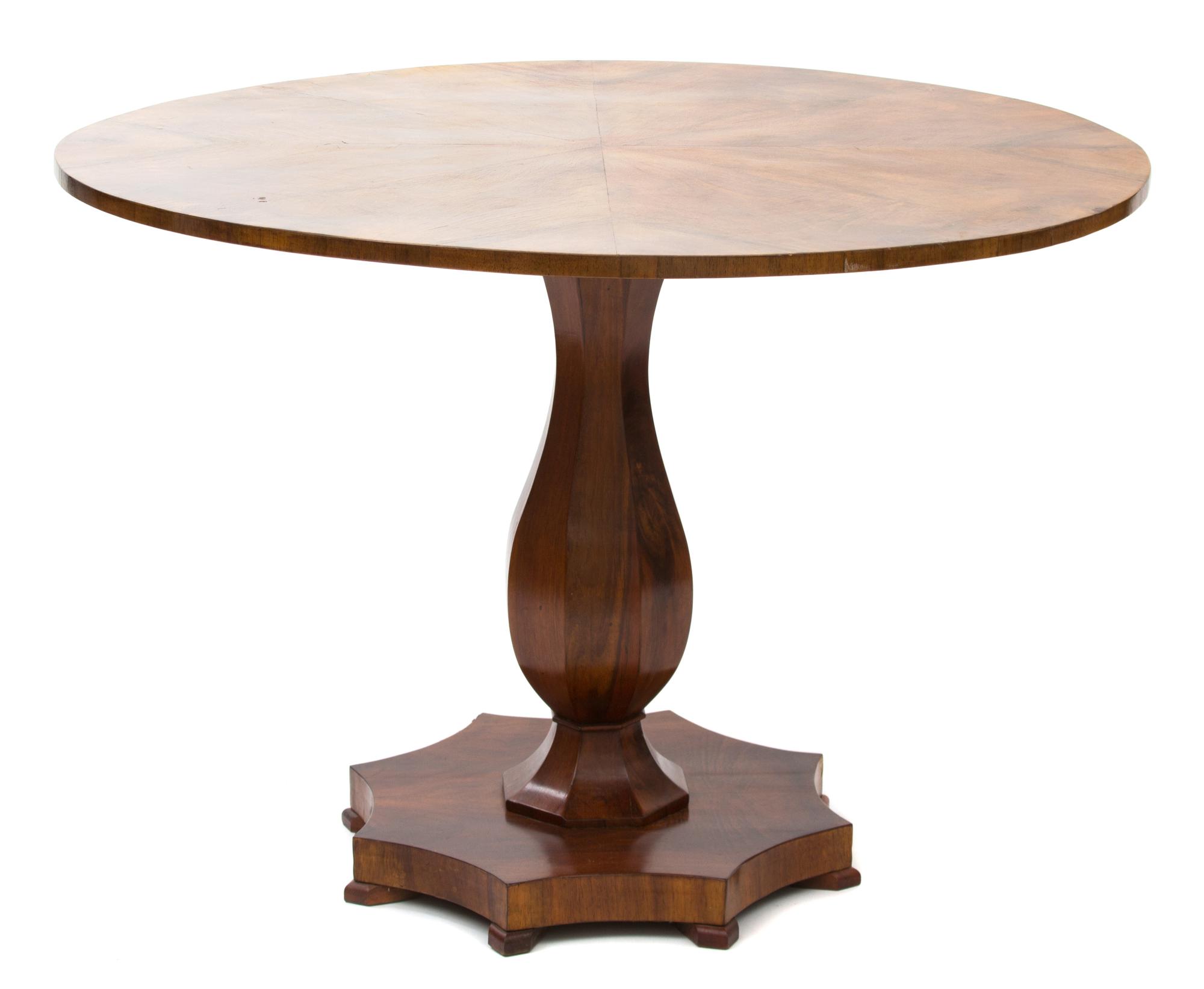 A Biedermeier Walnut Center Table Height 29 x diameter 42 inches. — SECOND QUARTER 19TH CENTURY