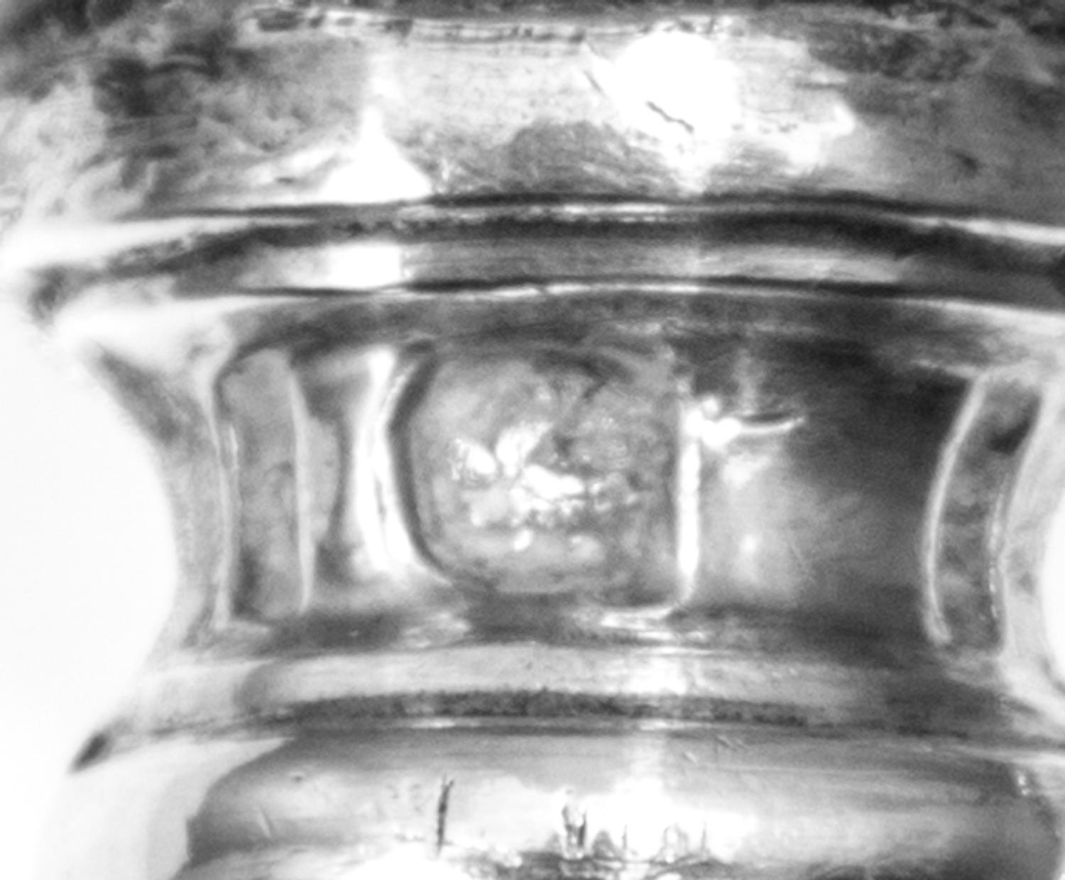 A Group of Four French Silver Bone Holders, various makers, the handles worked to show floral and ribbon swags, comprising three standa