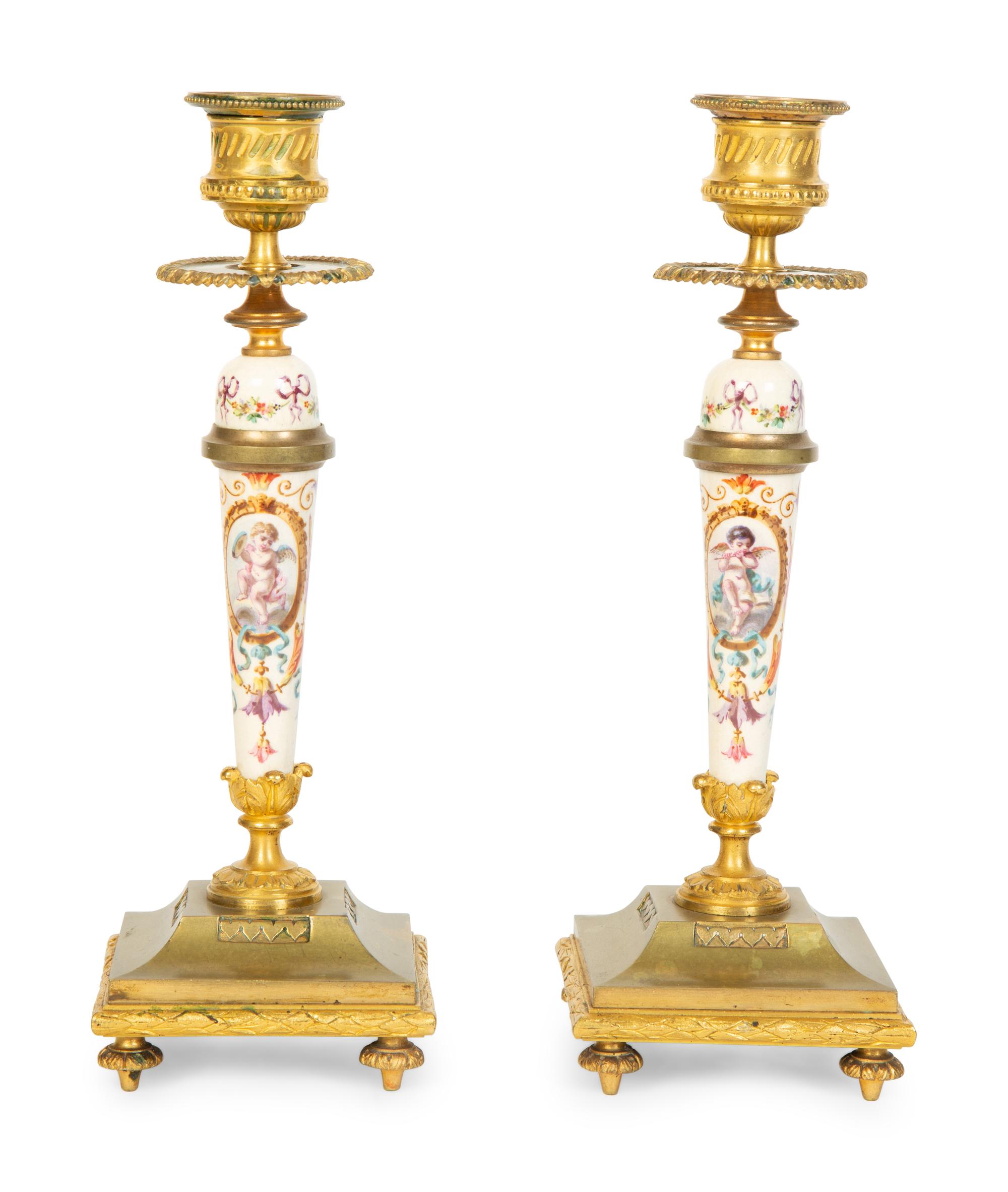 A Pair of French Gilt Bronze and Painted Porcelain Candlesticks