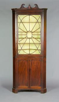 An English Mahogany Corner Cabinet, Height 77 1/2 x width 33 inches.