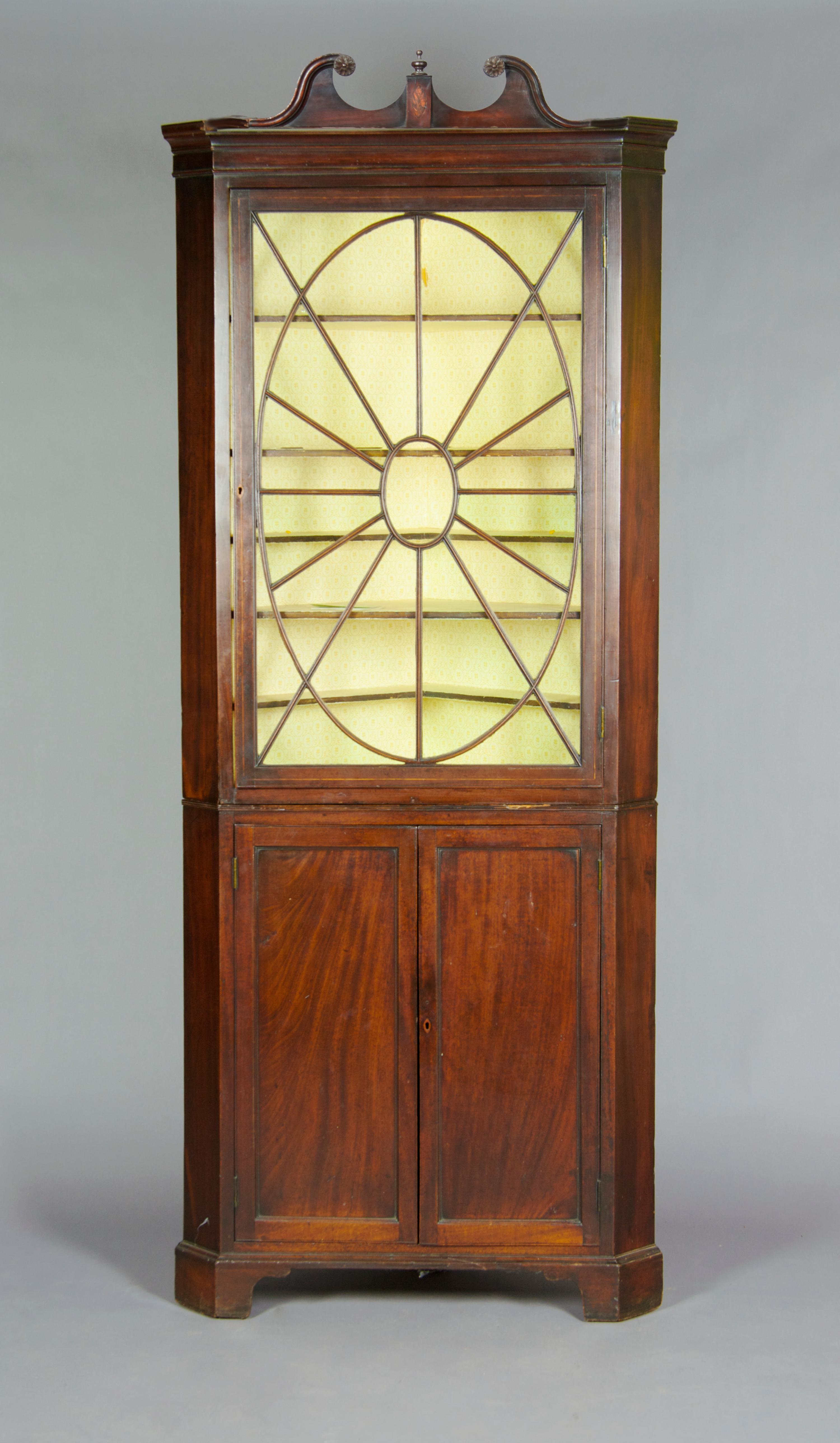 An English Mahogany Corner Cabinet, Height 77 1/2 x width 33 inches.
