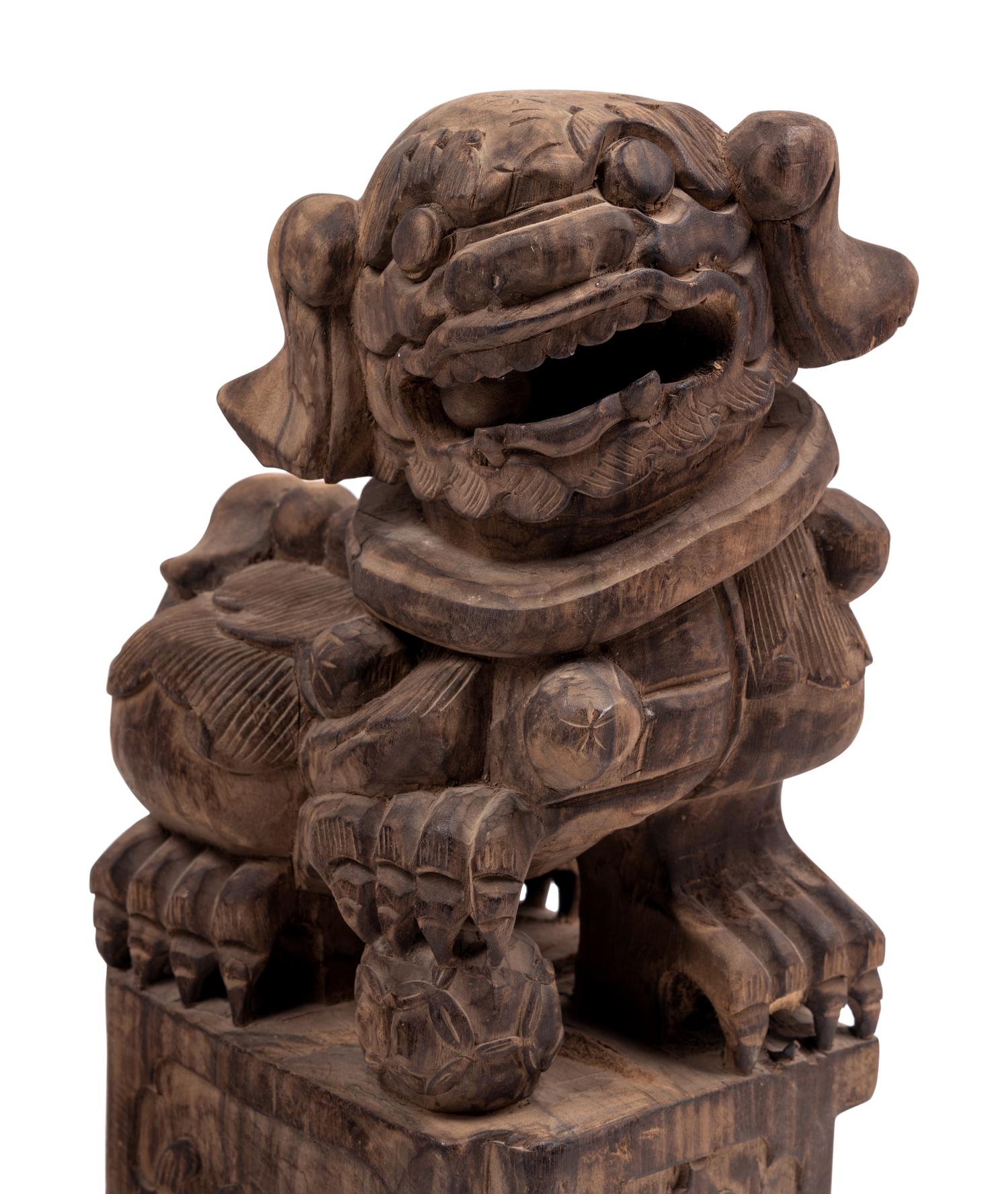 A Pair of Carved Wood Buddhistic Lions