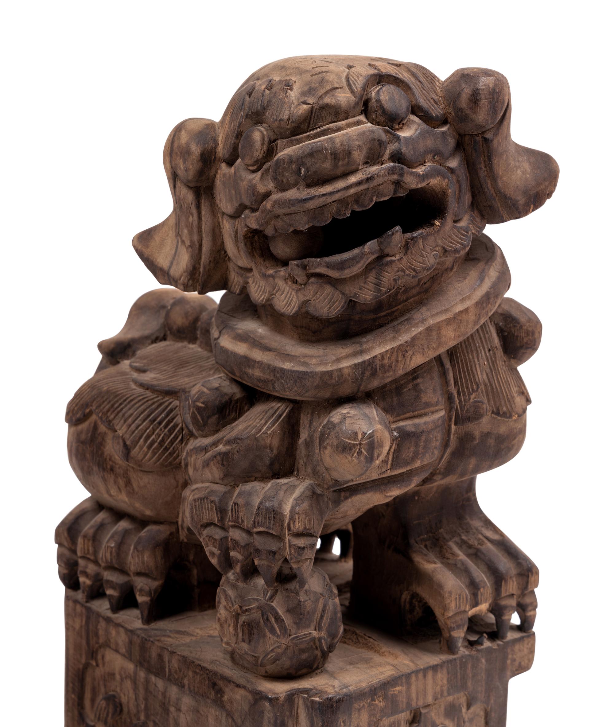 A Pair of Carved Wood Buddhistic Lions