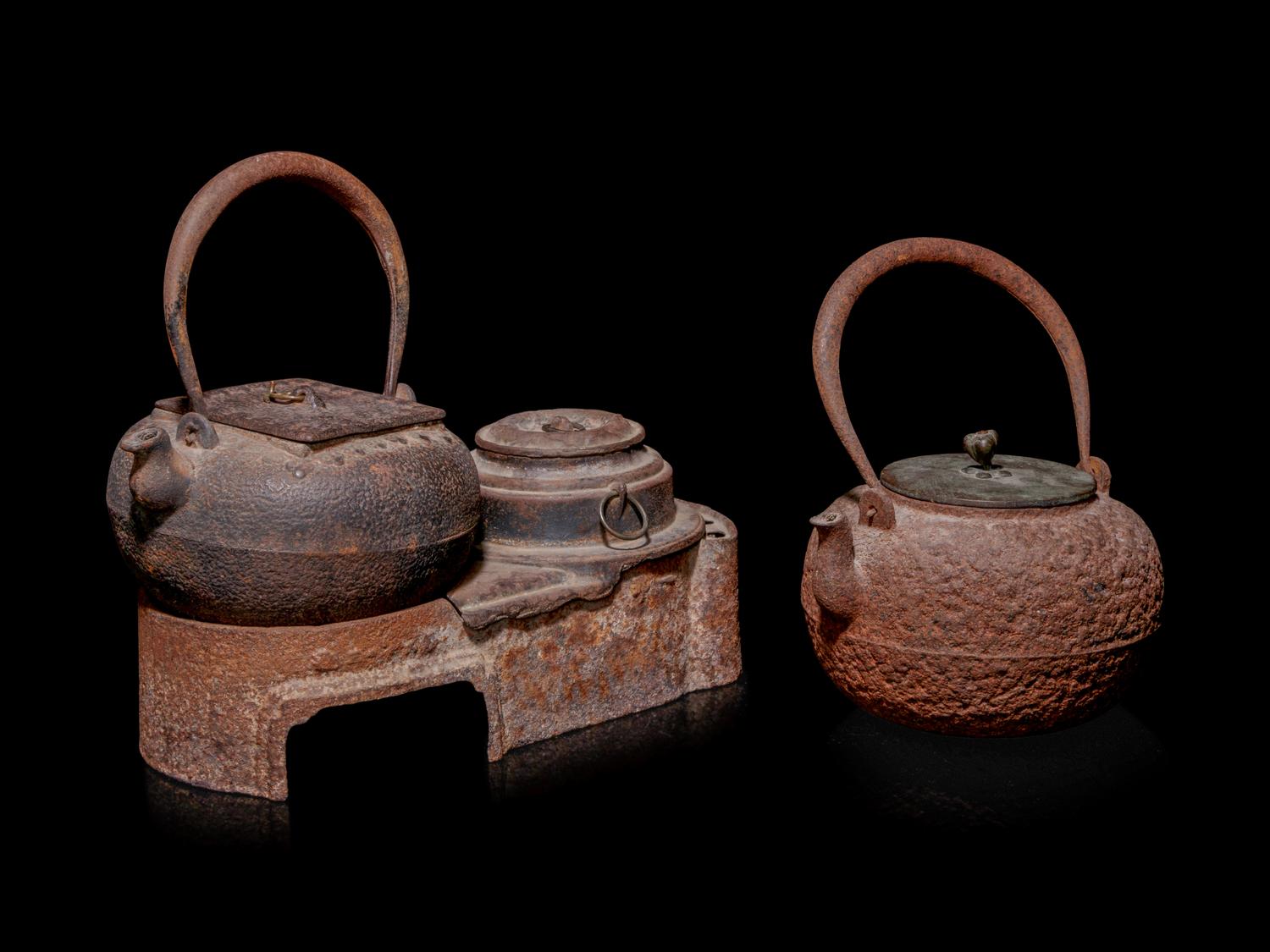 Seven Japanese Cast Iron Teapots, Tetsubin, and Burner