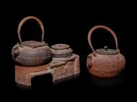 Seven Japanese Cast Iron Teapots, Tetsubin, and Burner
