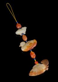 Three Carved Jade Pendants Height overall 9 inches.