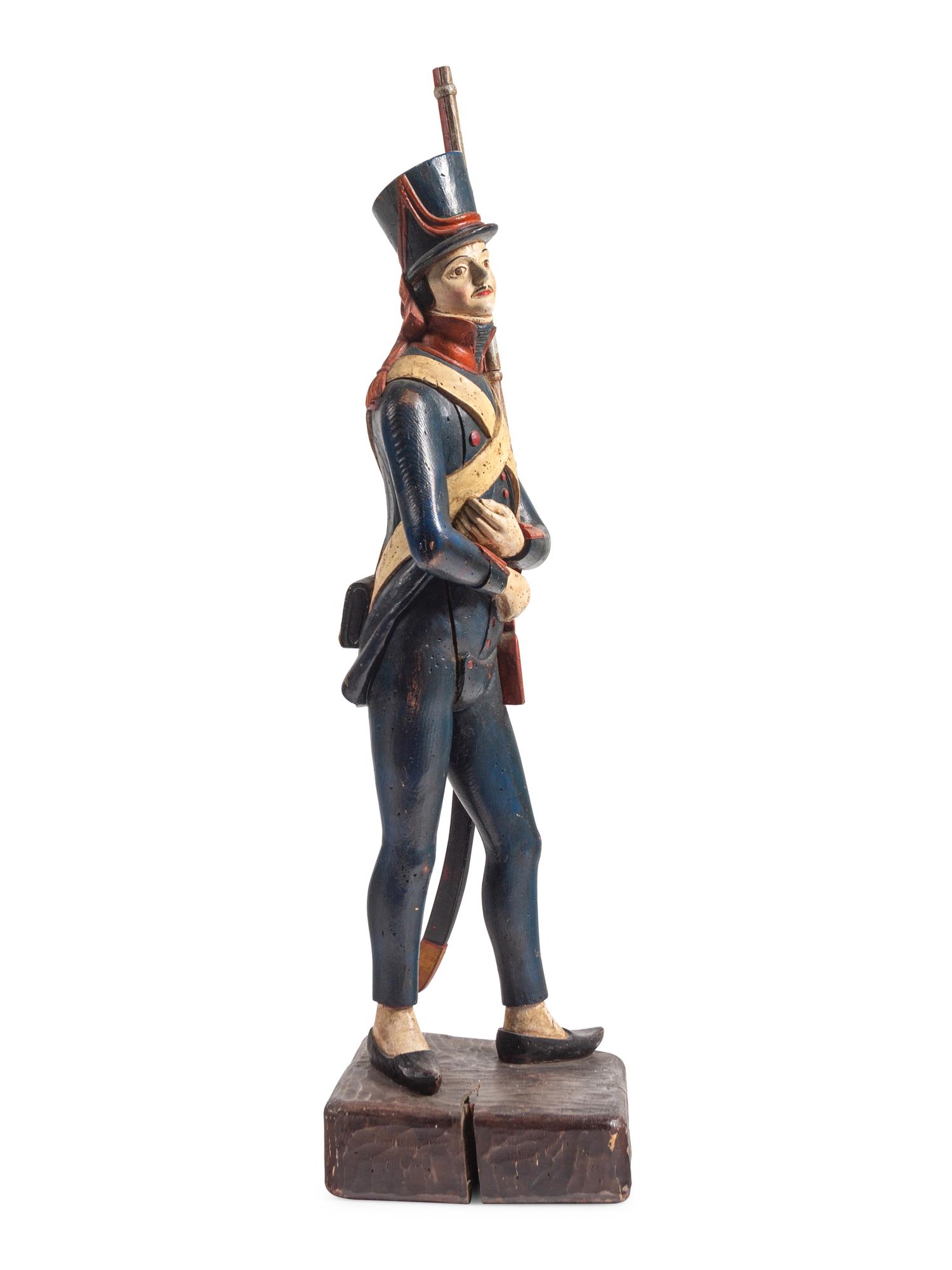 A Carved and Painted Wood Figure of a Soldier