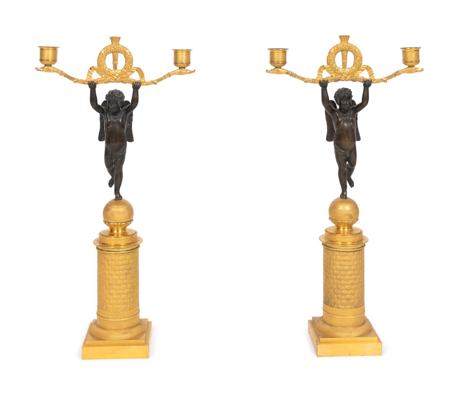 A Pair of Empire Style Parcel-Gilt and Patinated Bronze Figural Two-Light Candelabra