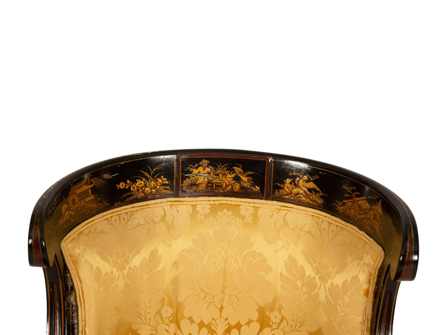 A Pair of Regency Ebonized and Gilt Barrel Back Armchairs