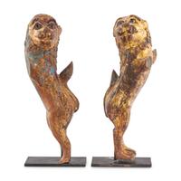 A Pair of Parcel-Gilt and Polychrome Decorated Lion-Form Crest Supporters