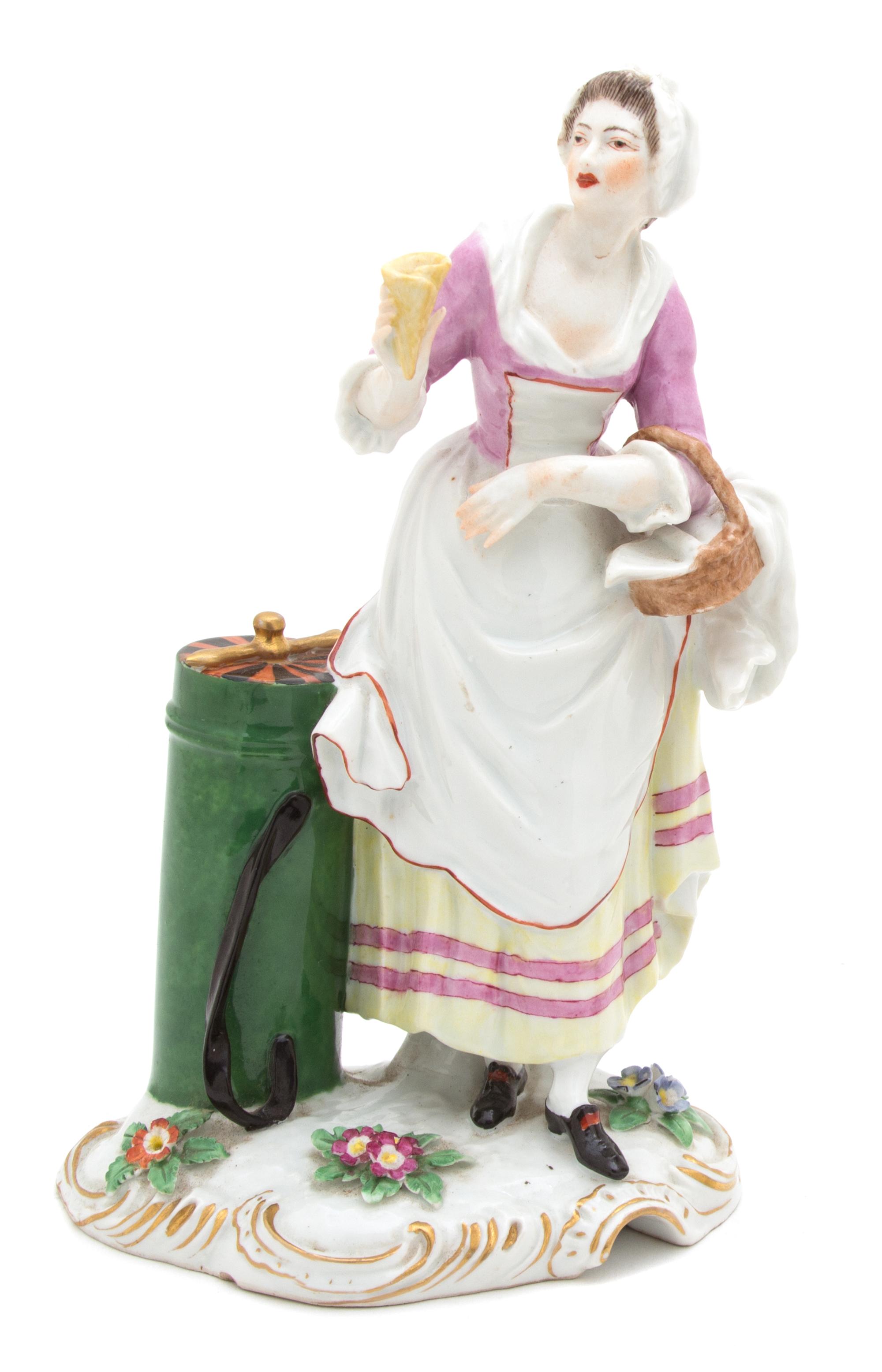 A German Porcelain Figure of a Female Street Vendor Height 8 3/4 inches. — 19TH CENTURY