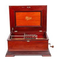 A Mira 15 1/2 Inch Disc Music Box and Seventeen Discs