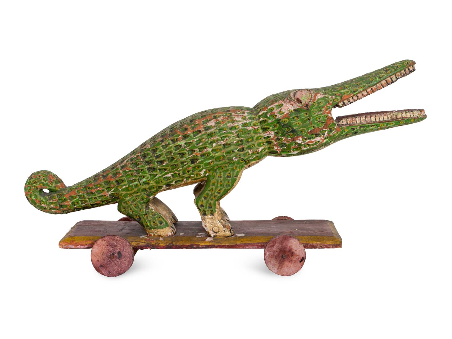 A Folk Art Polychrome Decorated Crocodile Pull-Toy
