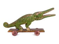 A Folk Art Polychrome Decorated Crocodile Pull-Toy