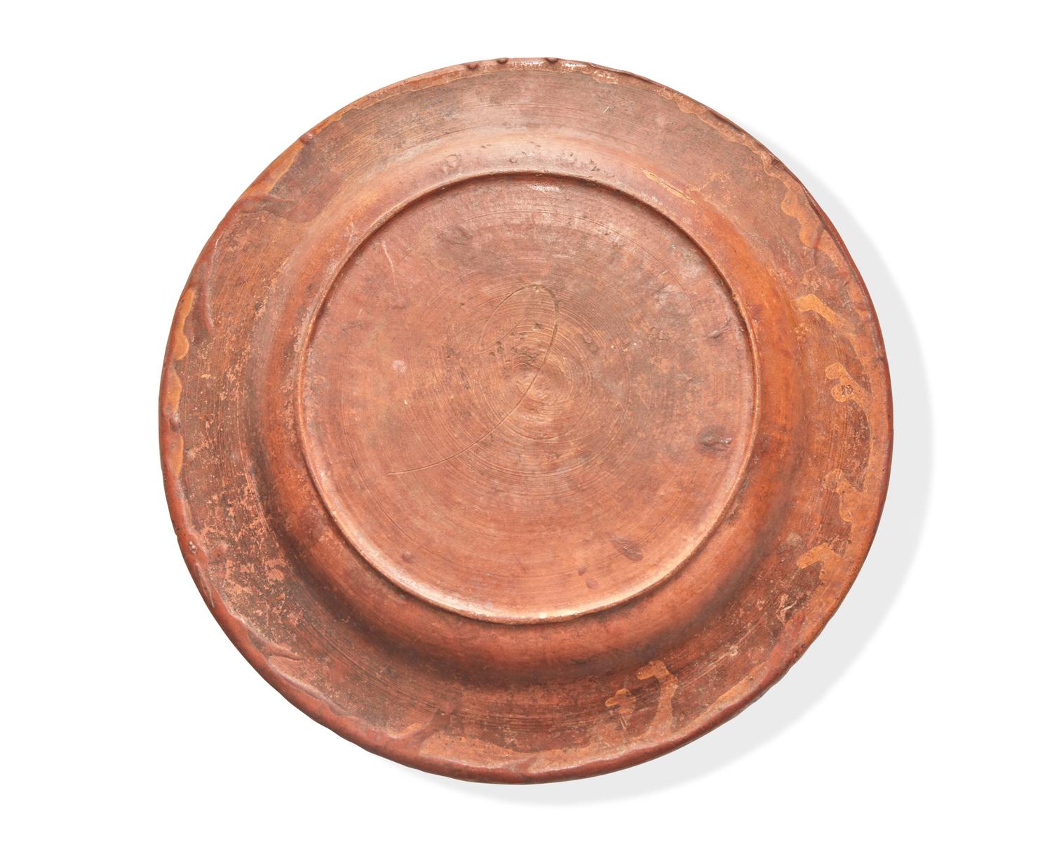 A Glazed and Slip-Decorated Redware Plate, Continental, 19th Century