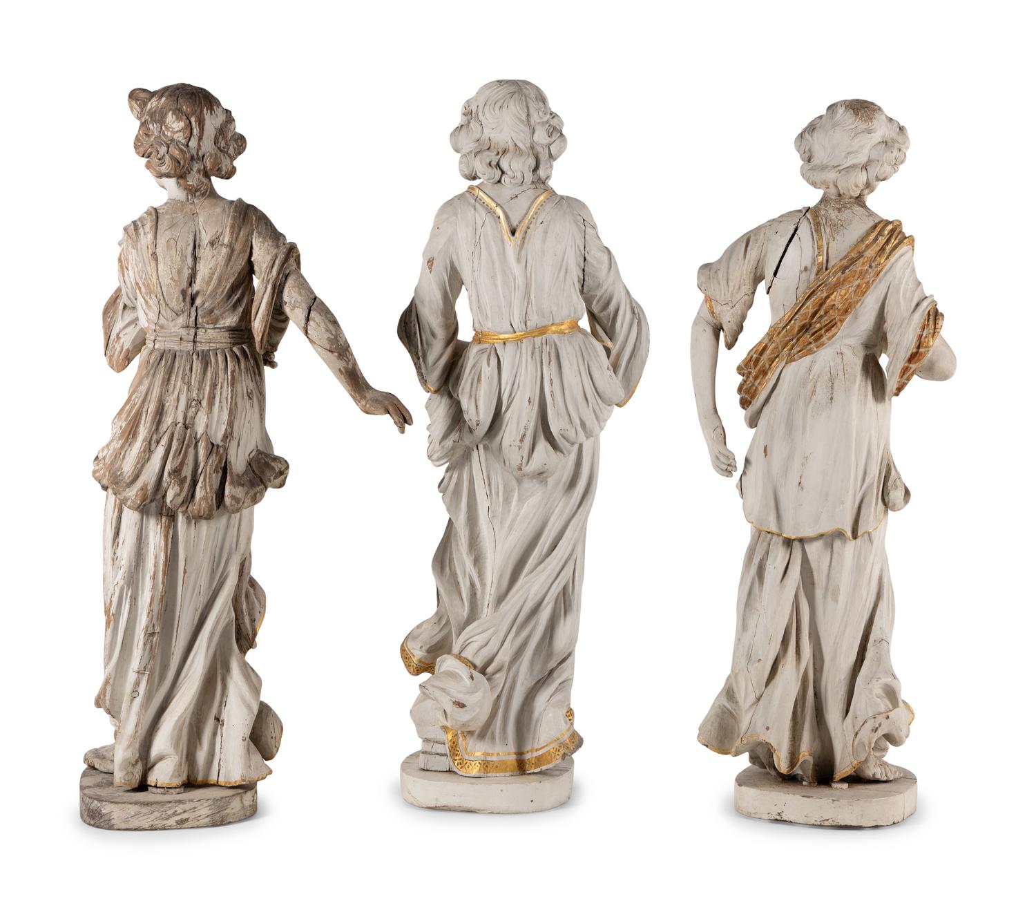 A Set of Three Carved, Painted and Parcel Gilt Wood Figures