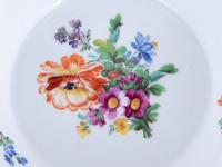 Three Meissen Painted and Parcel Gilt Porcelain Cup and Saucer Sets, a Covered Cup and Two Spoons