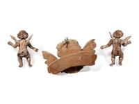 A Continental Carved Cherub Mask with Two Painted Putti