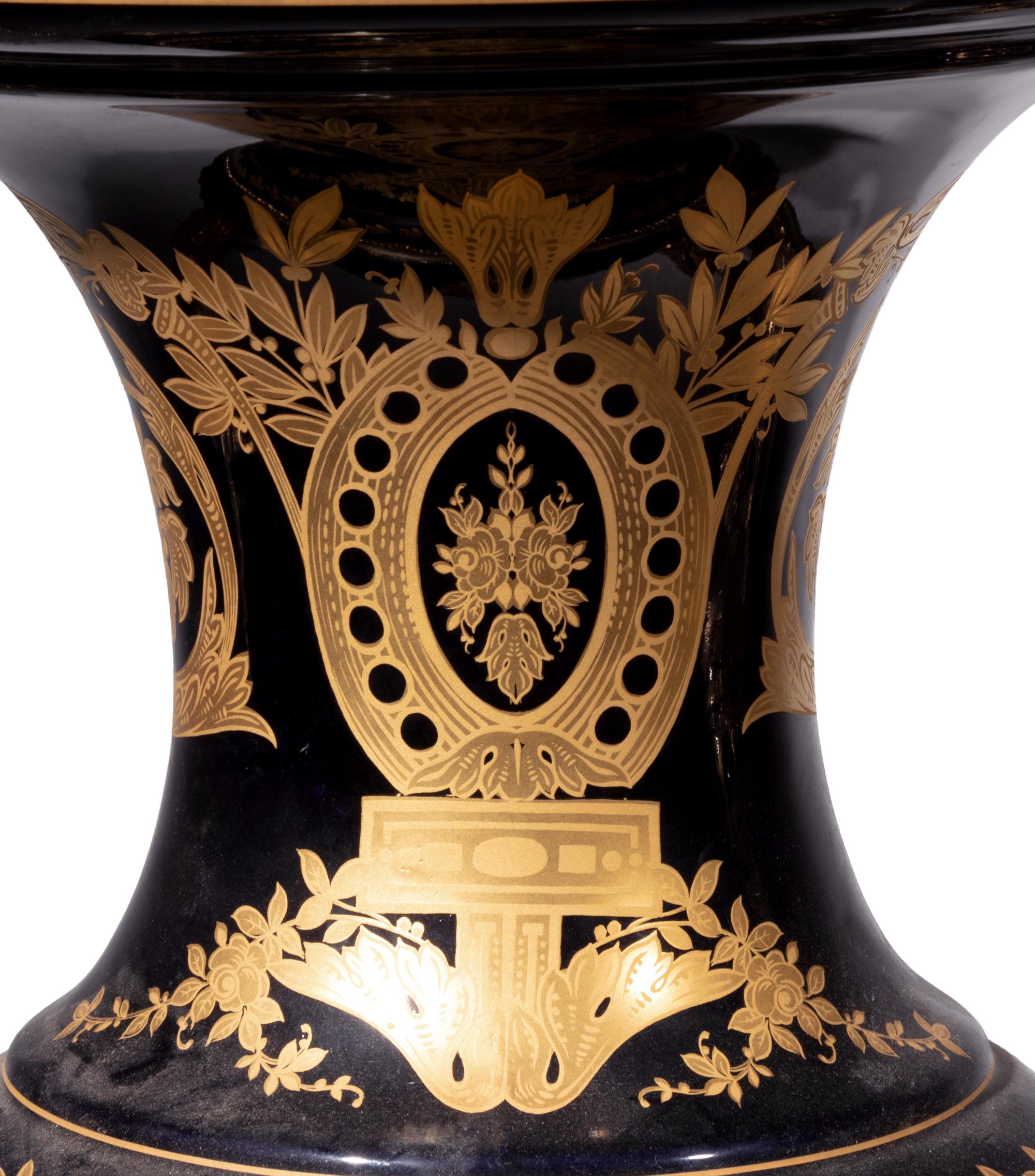 A Pair of Monumental Sèvres Style Gilt Metal Mounted Porcelain Covered Urns on Pedestals