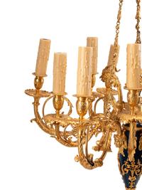 A French Neoclassical Gilt and Patinated Bronze Twelve-Light Chandelier