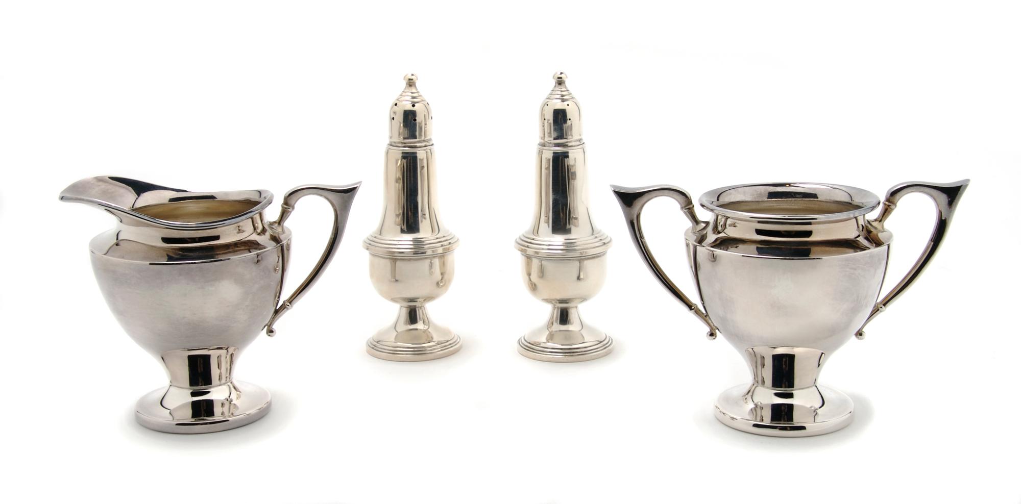 A Group of Two American Sterling Silver Casters, Empire, Height of pair 5 1/8 inches.
