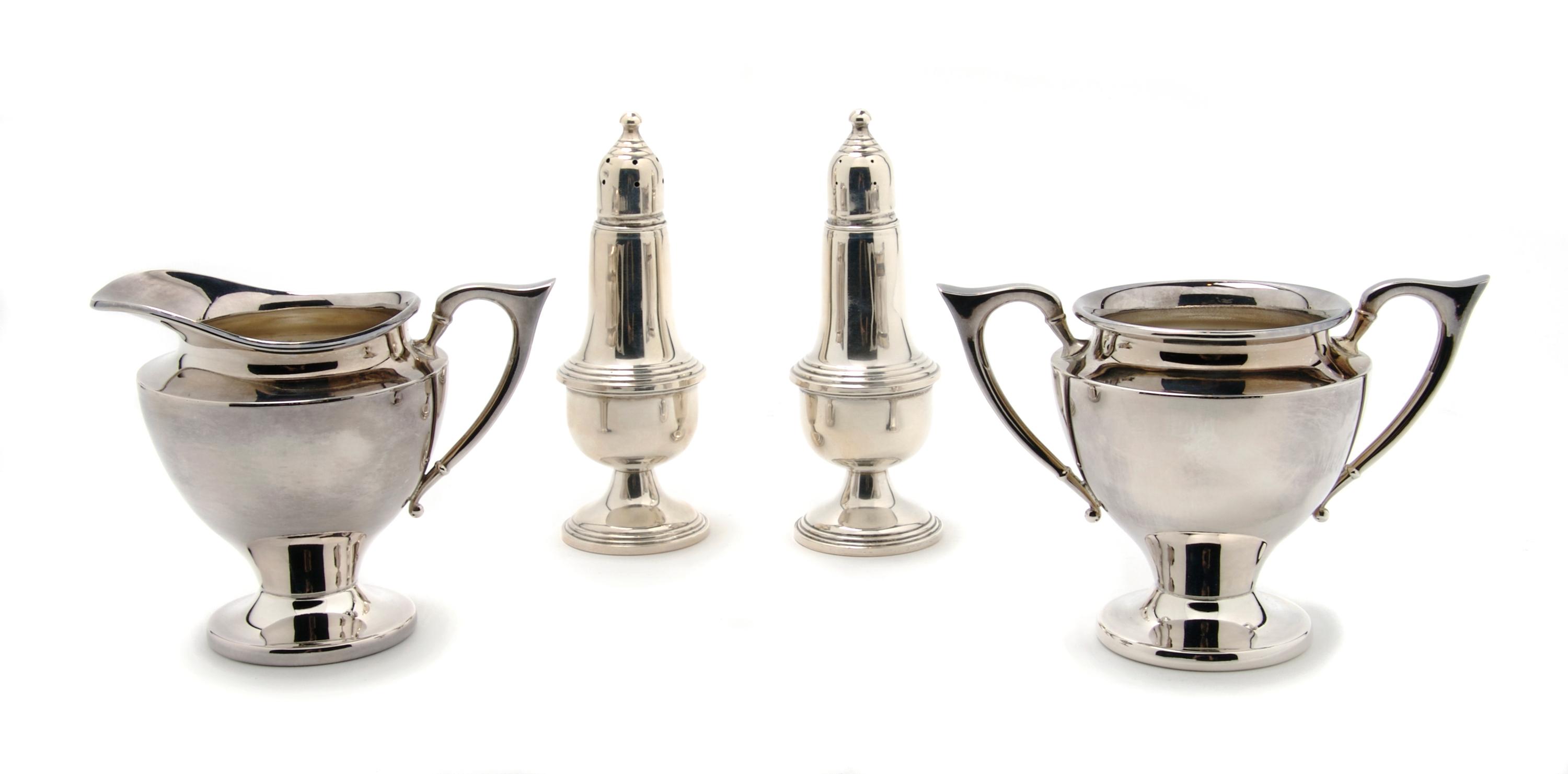 A Group of Two American Sterling Silver Casters, Empire, Height of pair 5 1/8 inches.