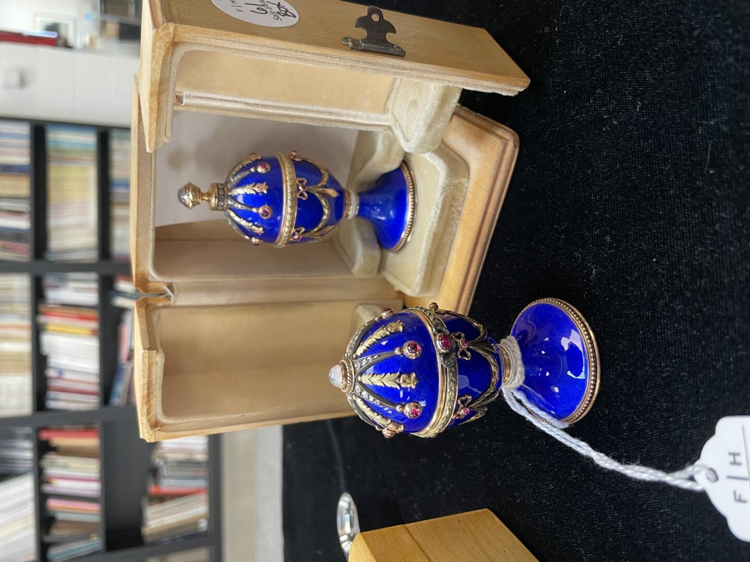 A 14 Karat Vari-Color Gold, Guilloché Enamel, Diamond, and Cabochon Jewel-Mounted Egg-Form Perfume and a Related Guilloché Enamel, 14 Karat Vari-Color Gold, Diamond, and Cabochon-Mounted Surprise Egg