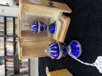 A 14 Karat Vari-Color Gold, Guilloché Enamel, Diamond, and Cabochon Jewel-Mounted Egg-Form Perfume and a Related Guilloché Enamel, 14 Karat Vari-Color Gold, Diamond, and Cabochon-Mounted Surprise Egg